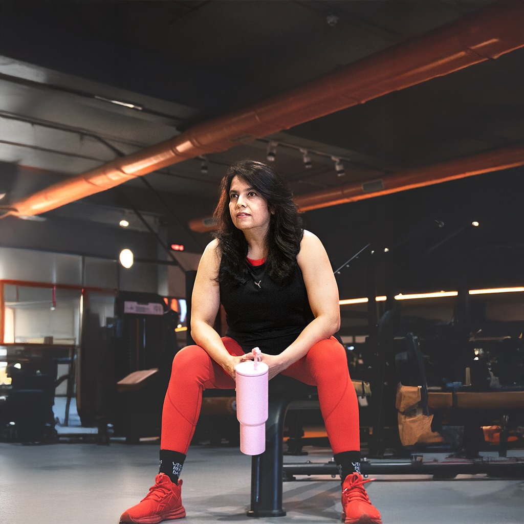 A woman training with focused form in a warm, low-lit studio